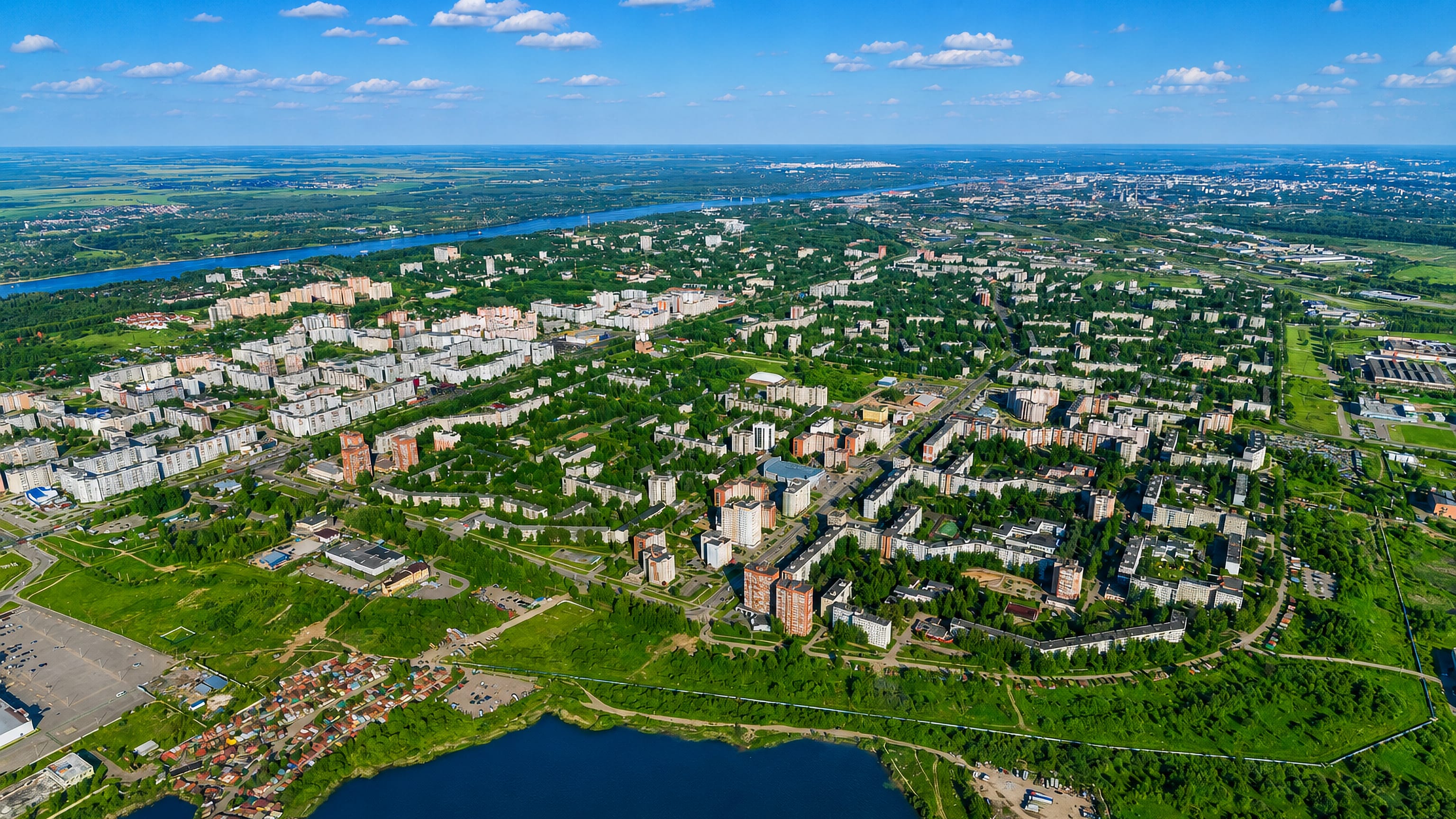 Aerial view of Bragino's Soviet-era apartment blocks in Yaroslavl, with the Volga river on the horizon.