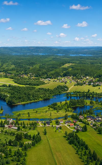 Aerial view over the forested Vasterdalalven river valley and scattered village of Malung in Dalarna, Sweden