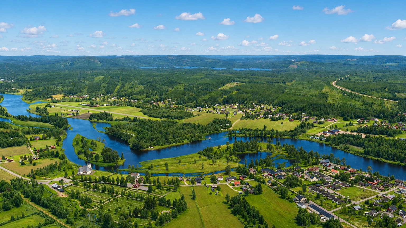 Aerial view over the forested Vasterdalalven river valley and scattered village of Malung in Dalarna, Sweden