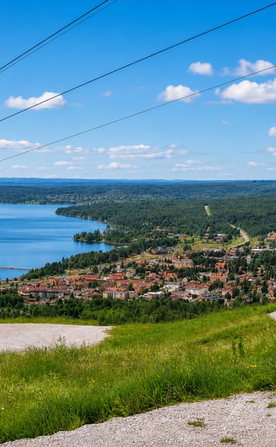 Rattvik, Sweden, along the shore of Lake Siljan with its long pier reaching into the water, seen from the hillside.