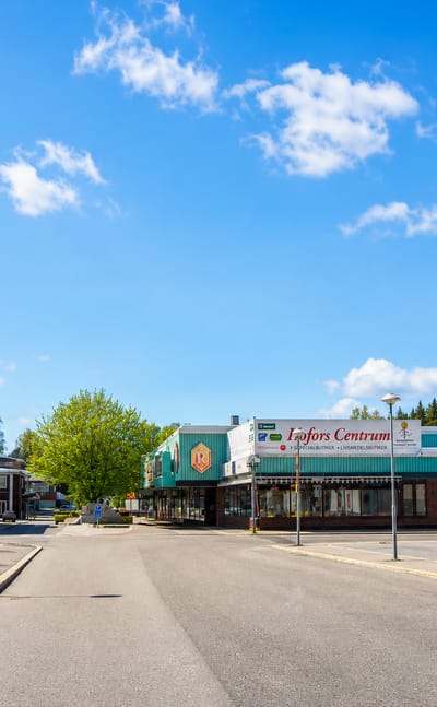 Hofors Centrum shops with a hotel, library and ELON store along the town centre street, Sweden.
