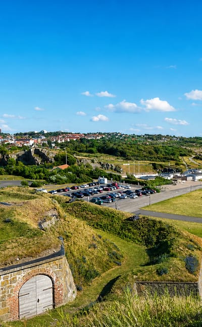 View from Varberg Fortress over its grassy ramparts toward the town and Kattegat coastline