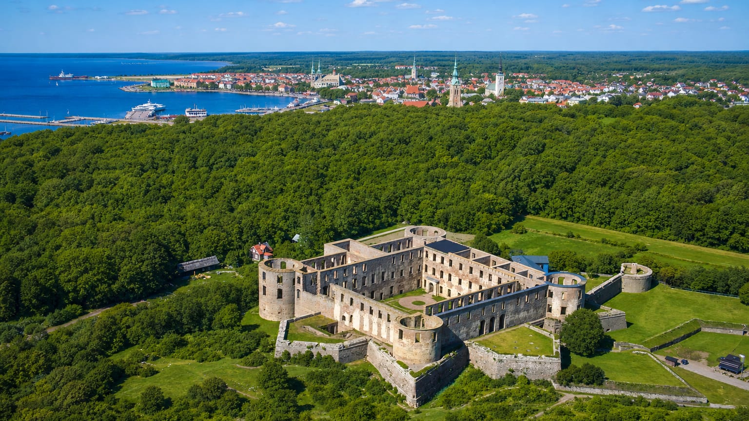 Aerial view of Borgholm Castle ruins above the town and harbour, Oland, Sweden