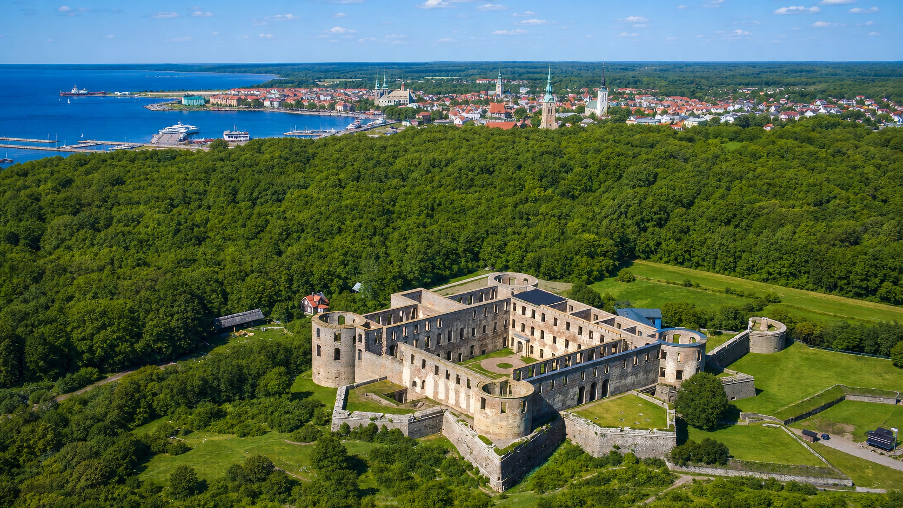 Aerial view of Borgholm Castle ruins above the town and harbour, Oland, Sweden