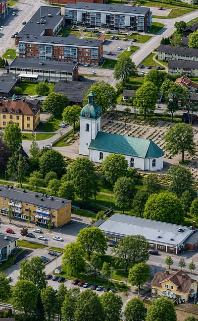 Aerial view of Asa, Sweden, centred on its green-domed church, main street and leafy town blocks
