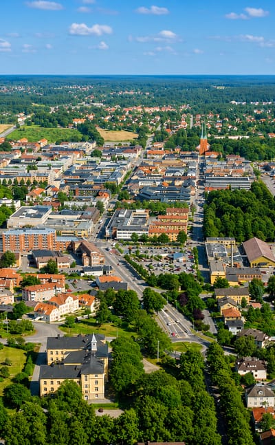Aerial view over the town of Vaxjo, Sweden, showing orange rooftops, lakes and surrounding forest