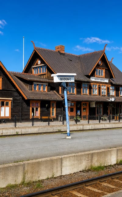 The ornate dark-timber Boden Central railway station under a blue sky in Boden, Sweden