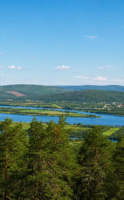 Panorama over the Torne River valley and forests toward the small town of Övertorneå, Sweden.