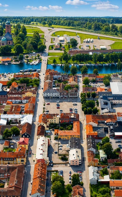 Aerial view of Askersund's lakeside old town with a church, red roofs and marina, Sweden