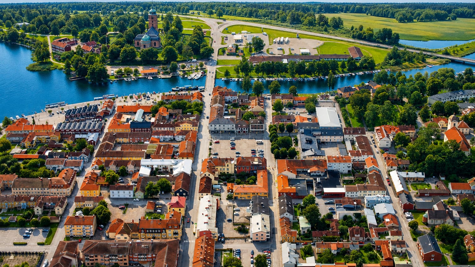 Aerial view of Askersund's lakeside old town with a church, red roofs and marina, Sweden