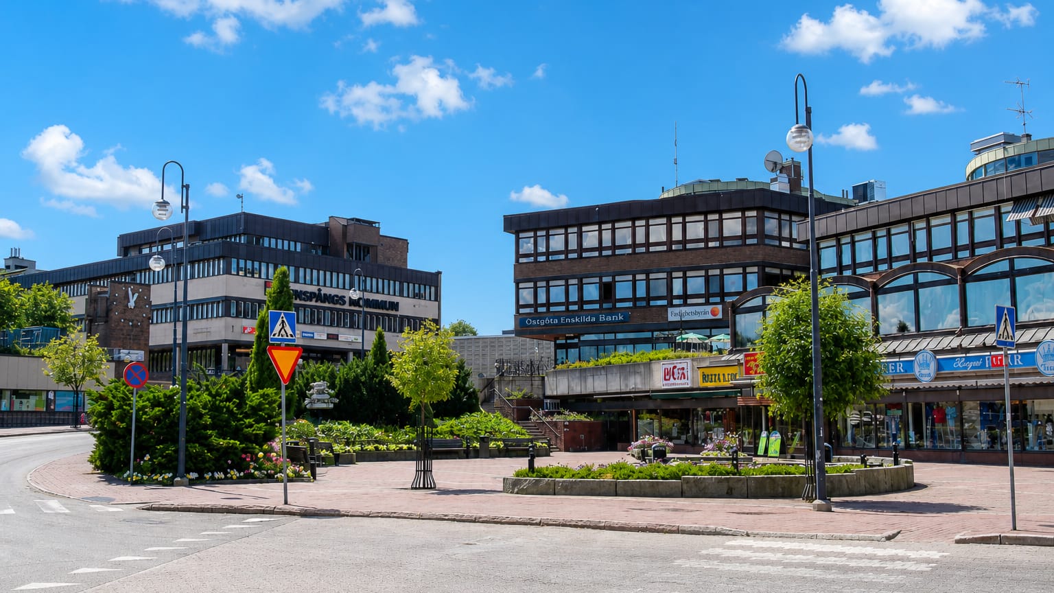 Central square in Finspang, Sweden, with the kommun building, Ostgota Enskilda Bank and shops under blue sky