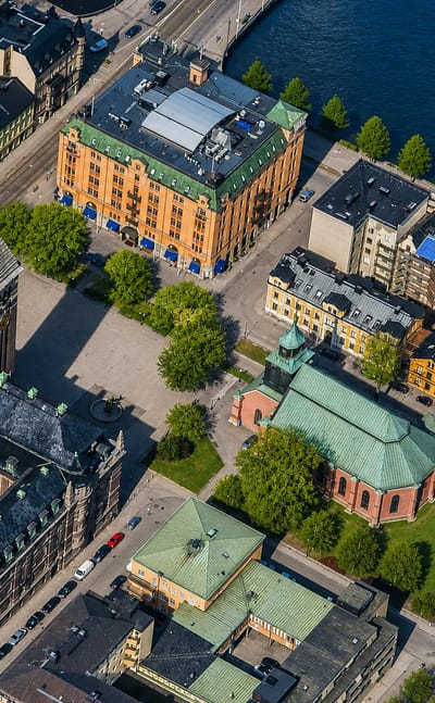 Aerial view over central Norrkoping, Sweden, showing riverside blocks with a church tower and domed church