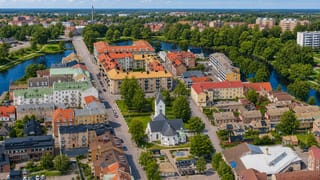 Aerial view of Angelholm with its white church, red-roofed blocks and the Ronne river looping through town
