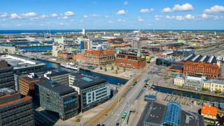Aerial over Malmo's harbour district with the Turning Torso tower rising in the distance