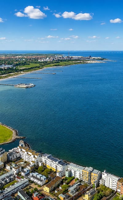 Aerial view of Västra Hamnen in Malmö, Sweden, with modern waterfront apartments, a beach and the Öresund strait.