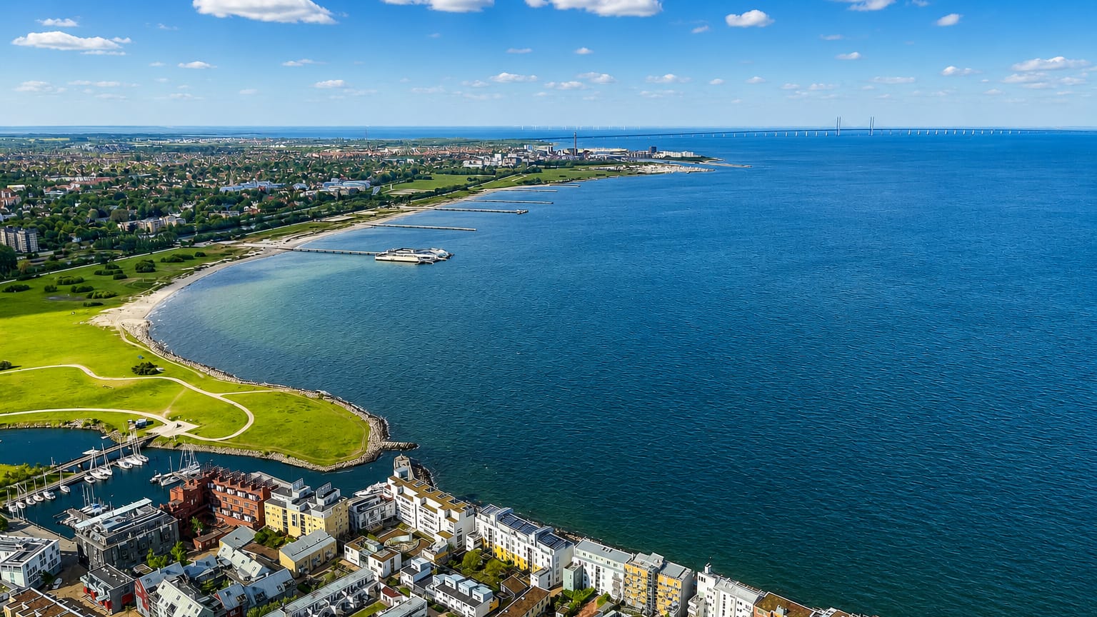 Aerial view of Västra Hamnen in Malmö, Sweden, with modern waterfront apartments, a beach and the Öresund strait.