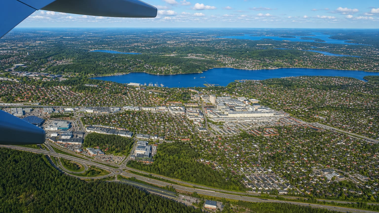 Aerial view from a plane over Sollentuna's suburbs, lakes and forests north of Stockholm, Sweden.