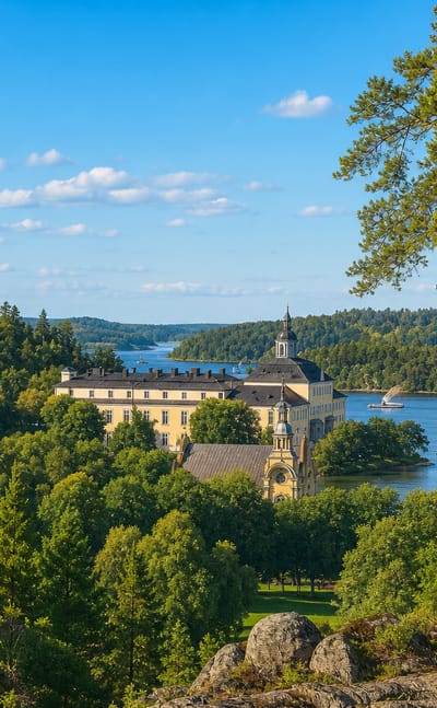 Ulriksdals slott, a yellow baroque royal palace on Edsviken bay, framed by tall pines and lush forest under a blue summer sky.