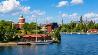 Stockholm waterfront by Djurgarden, with a moored sailing ship, the Kastellet tower and Nordiska museet spires