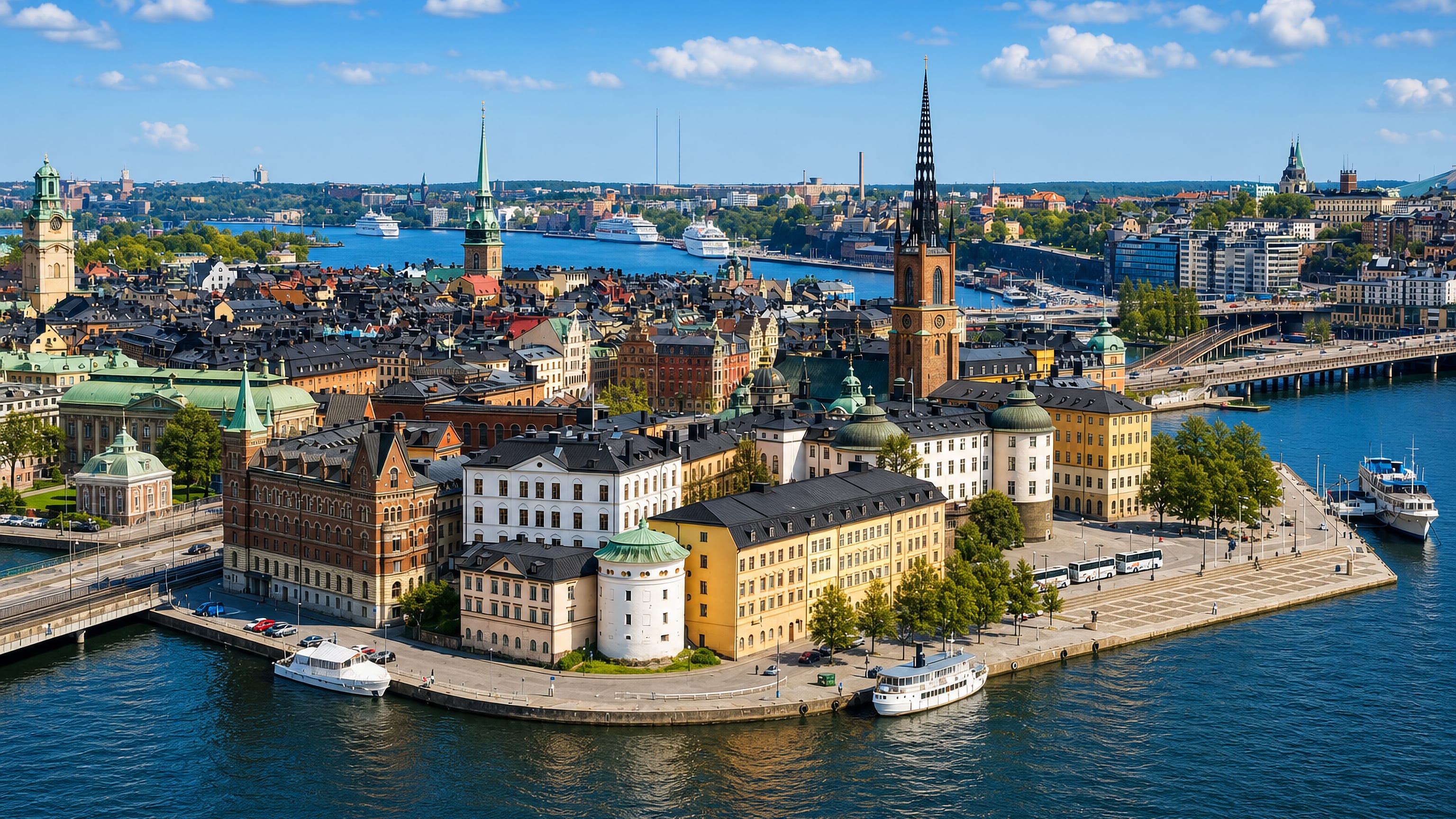 Aerial view of Riddarholmen island in Stockholm, its cast-iron church spire rising above quayside palaces and boats.
