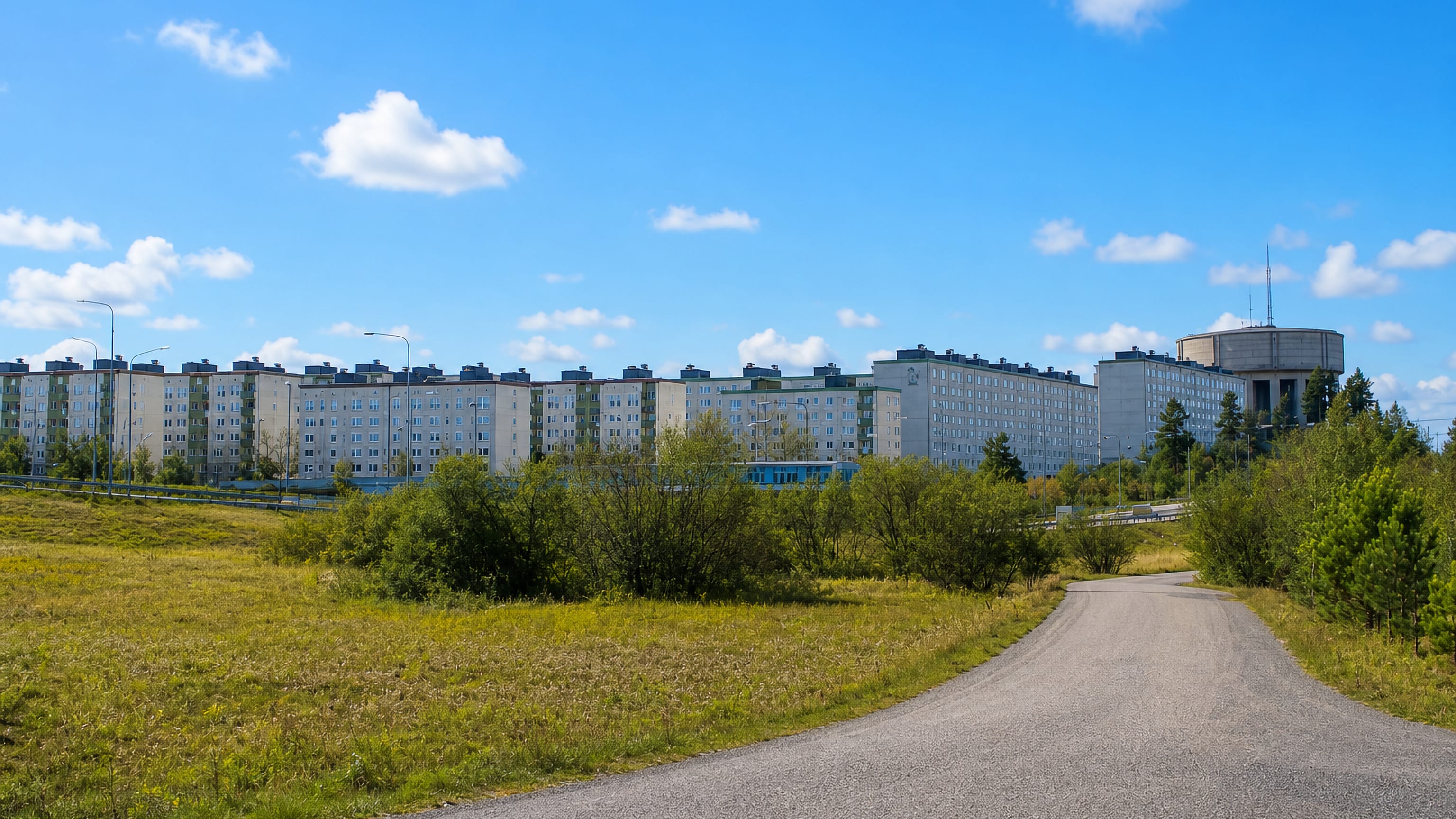Long Million Programme apartment slabs above a meadow and footpath in Tensta, northern Stockholm.