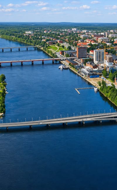 Aerial view of Umea straddling the Ume River with its bridges, riverside buildings and a church spire