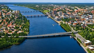Aerial view of Umea straddling the Ume River with its bridges, riverside buildings and a church spire