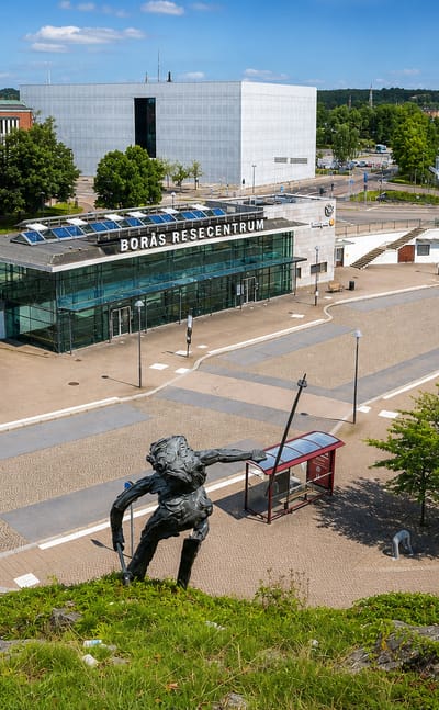 Boras Resecentrum travel hub and its plaza sculpture in central Boras, Sweden, under a clear summer sky.