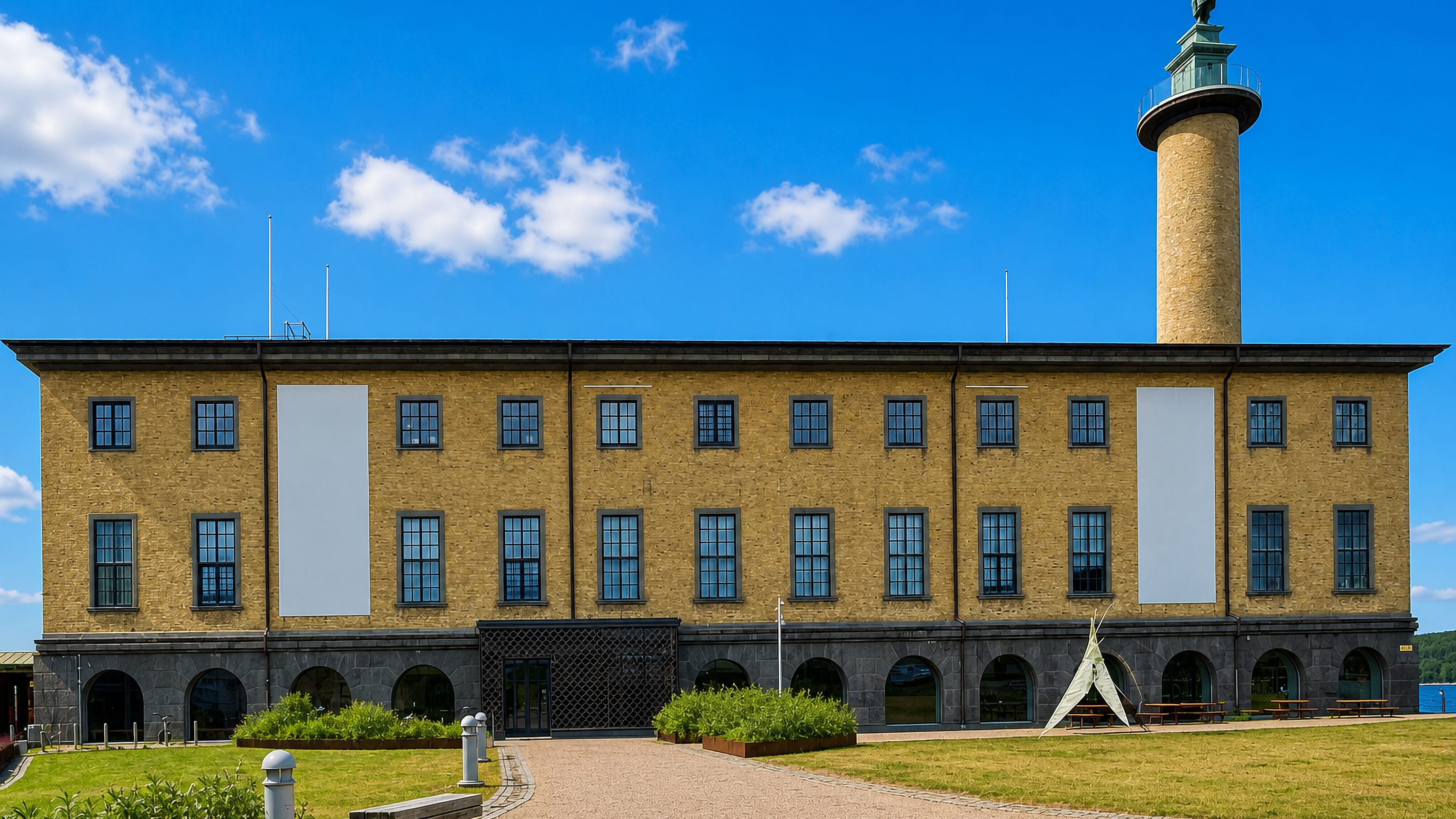 Yellow-brick maritime museum and its statue-topped seafarers' tower at Stigbergstorget in Majorna, Gothenburg.
