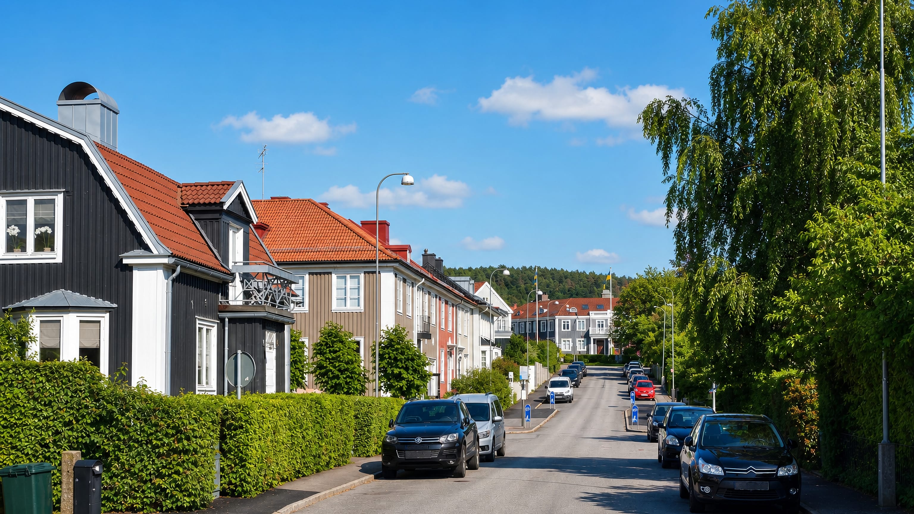 Wooden houses with red tile roofs and clipped hedges line a quiet residential street in Skår, Gothenburg.