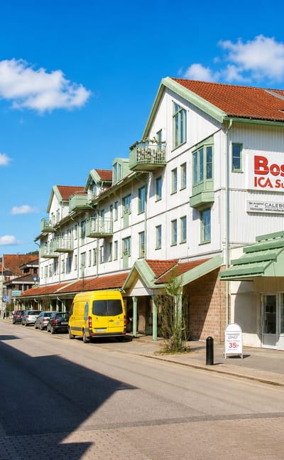 Main street with an ICA supermarket and hair salon in riverside Lilla Edet, Sweden.