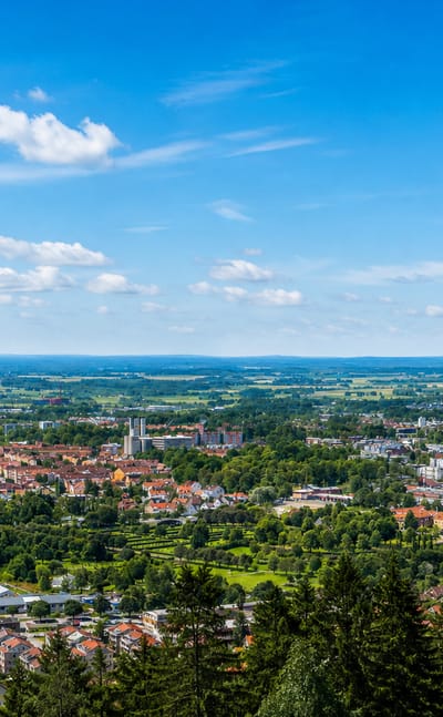 Elevated panorama over Skovde with its church tower amid green suburbs and distant plains