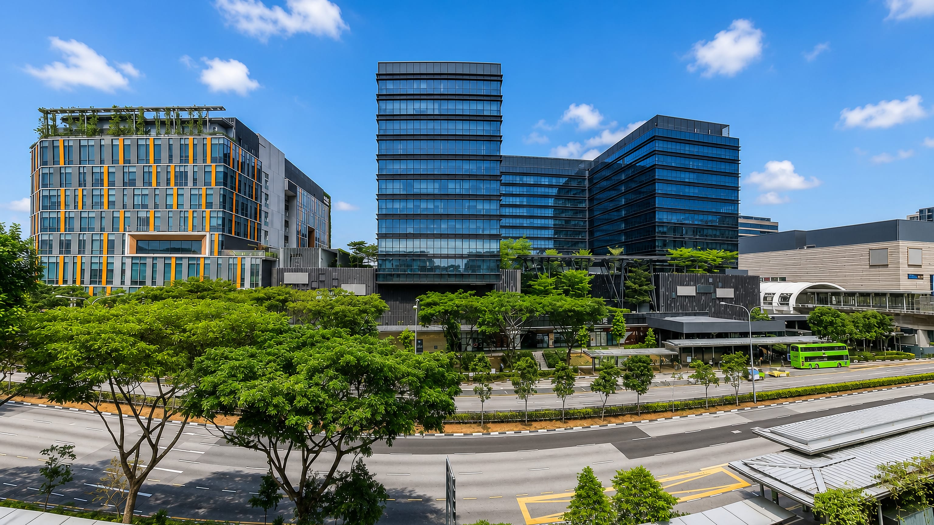 Glass office towers, green landscaping and the MRT station at Paya Lebar Central, Singapore.
