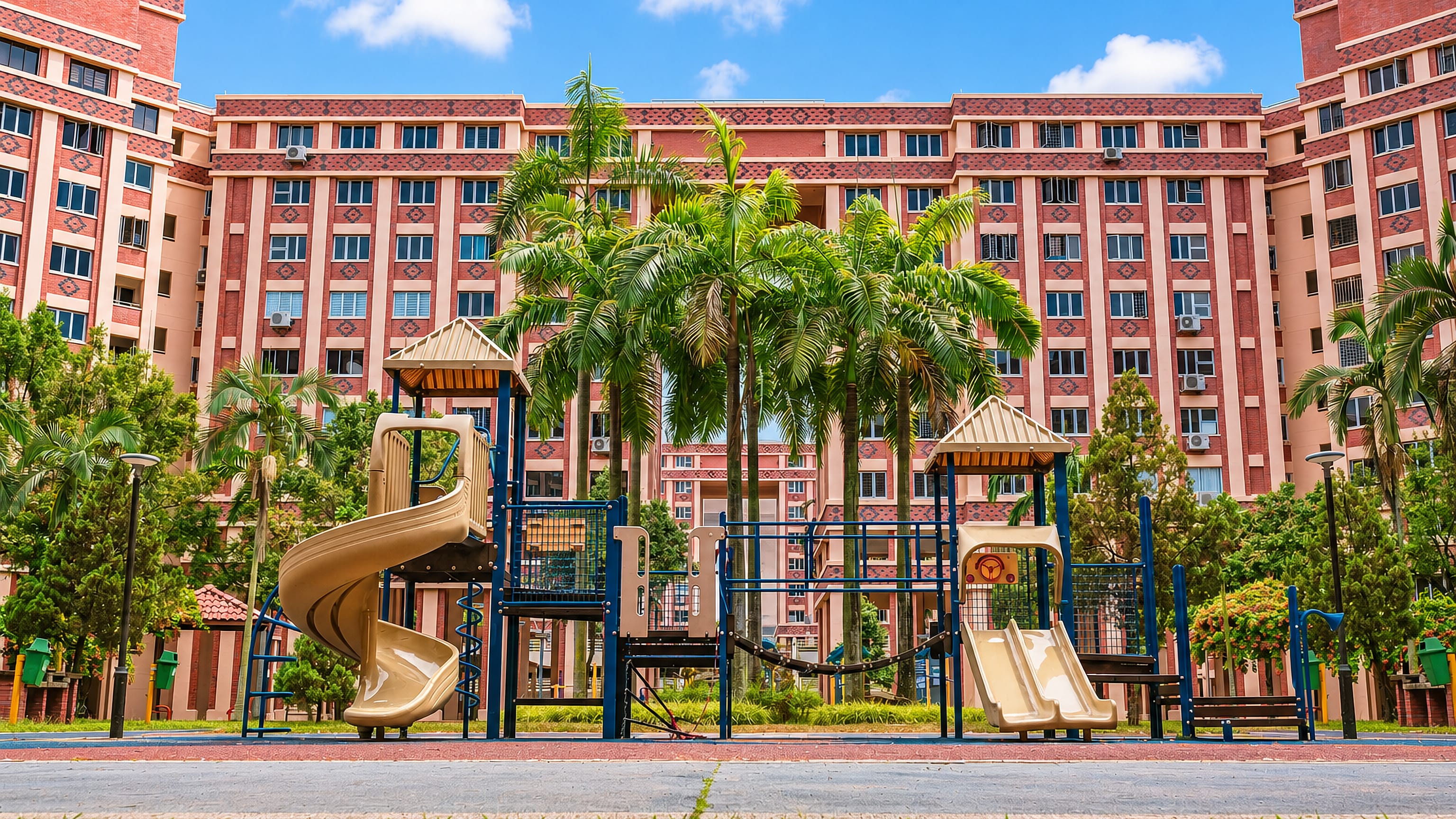 Playground and palm trees in front of red-brick HDB blocks in Tampines New Town, Singapore.