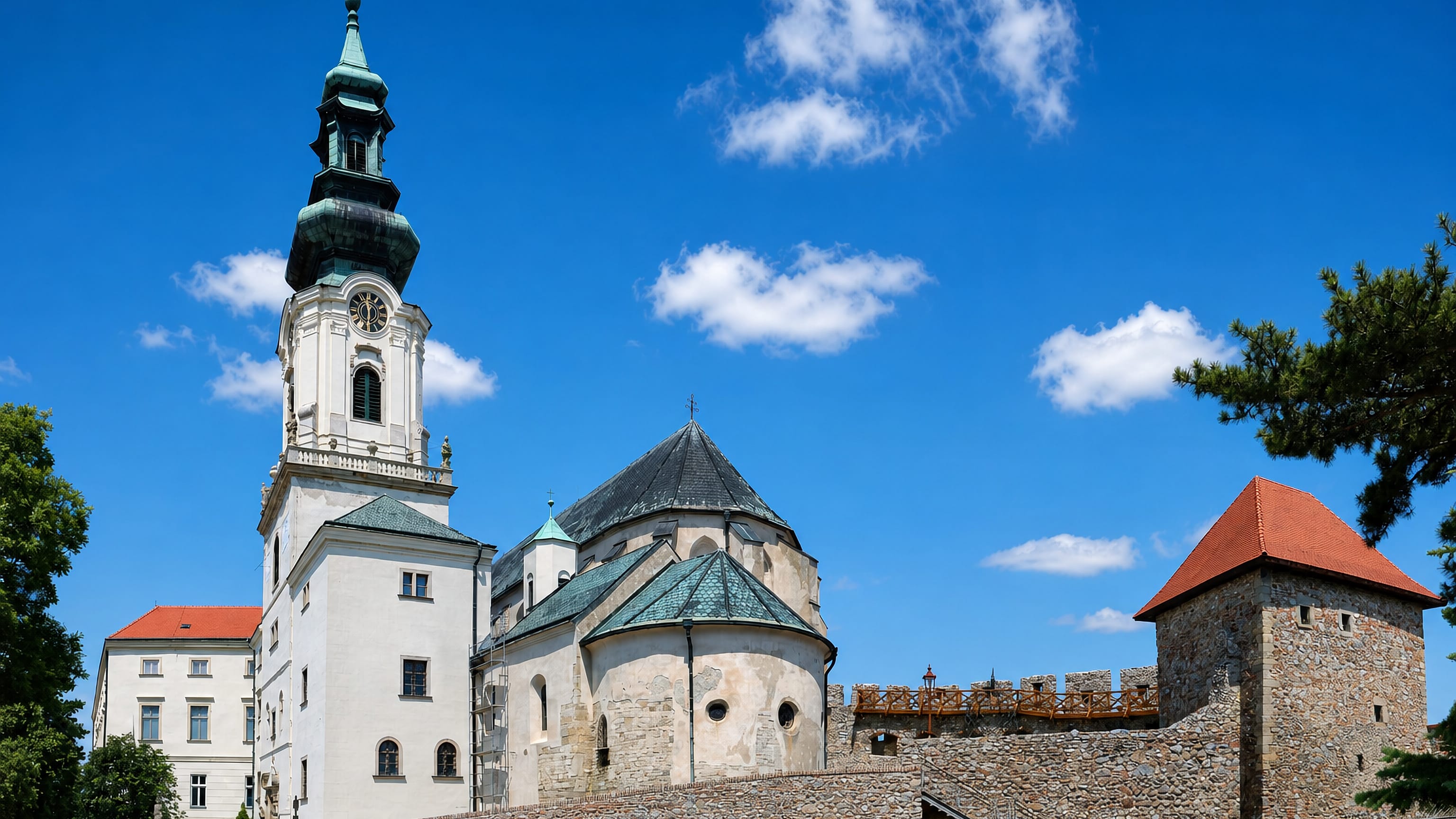 Nitra Castle and St. Emmeram's Cathedral rising above the stone bastion walls under a clear blue sky