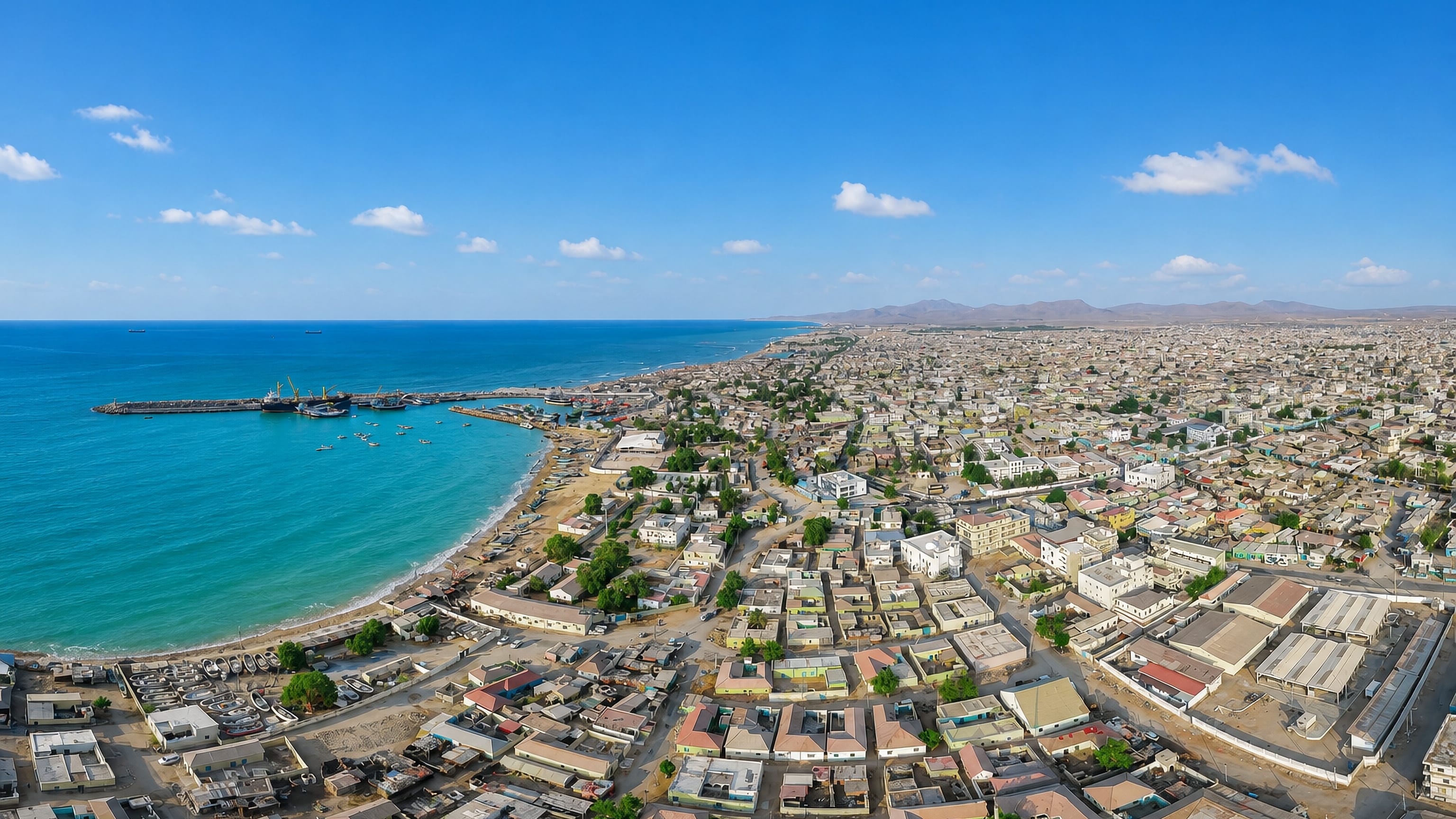 Bosaso spread along the Gulf of Aden shore, its port jetty and turquoise bay backed by arid hills.