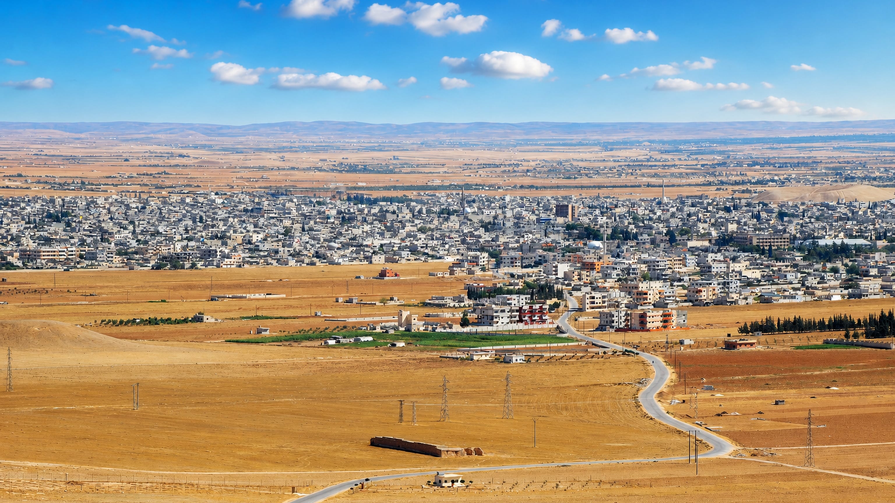 As Salamiyah's low white houses spread across the dry Hama steppe under a clear sky.