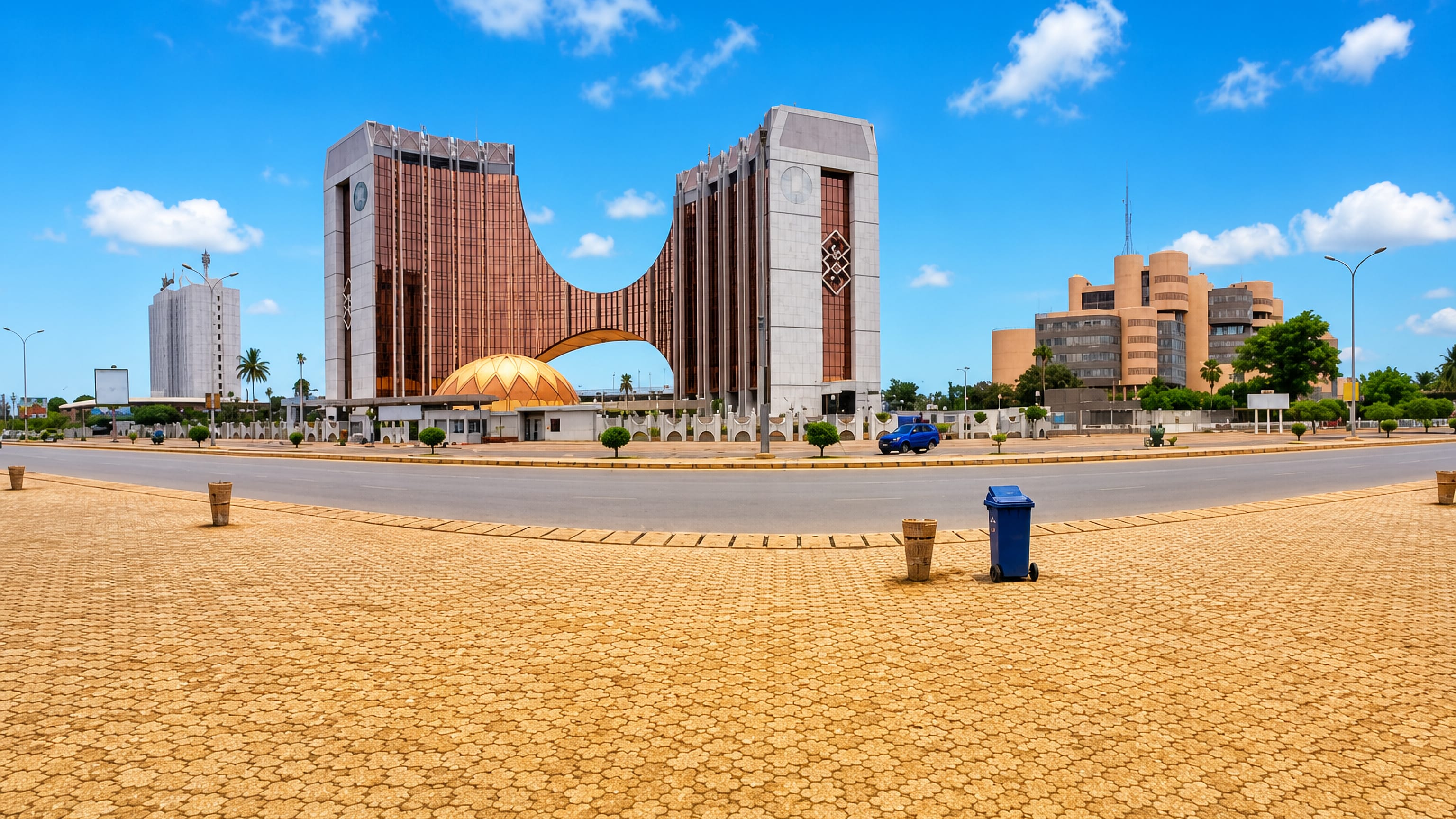 Lomé's landmark arched twin-tower bank headquarters and golden dome across a wide open plaza