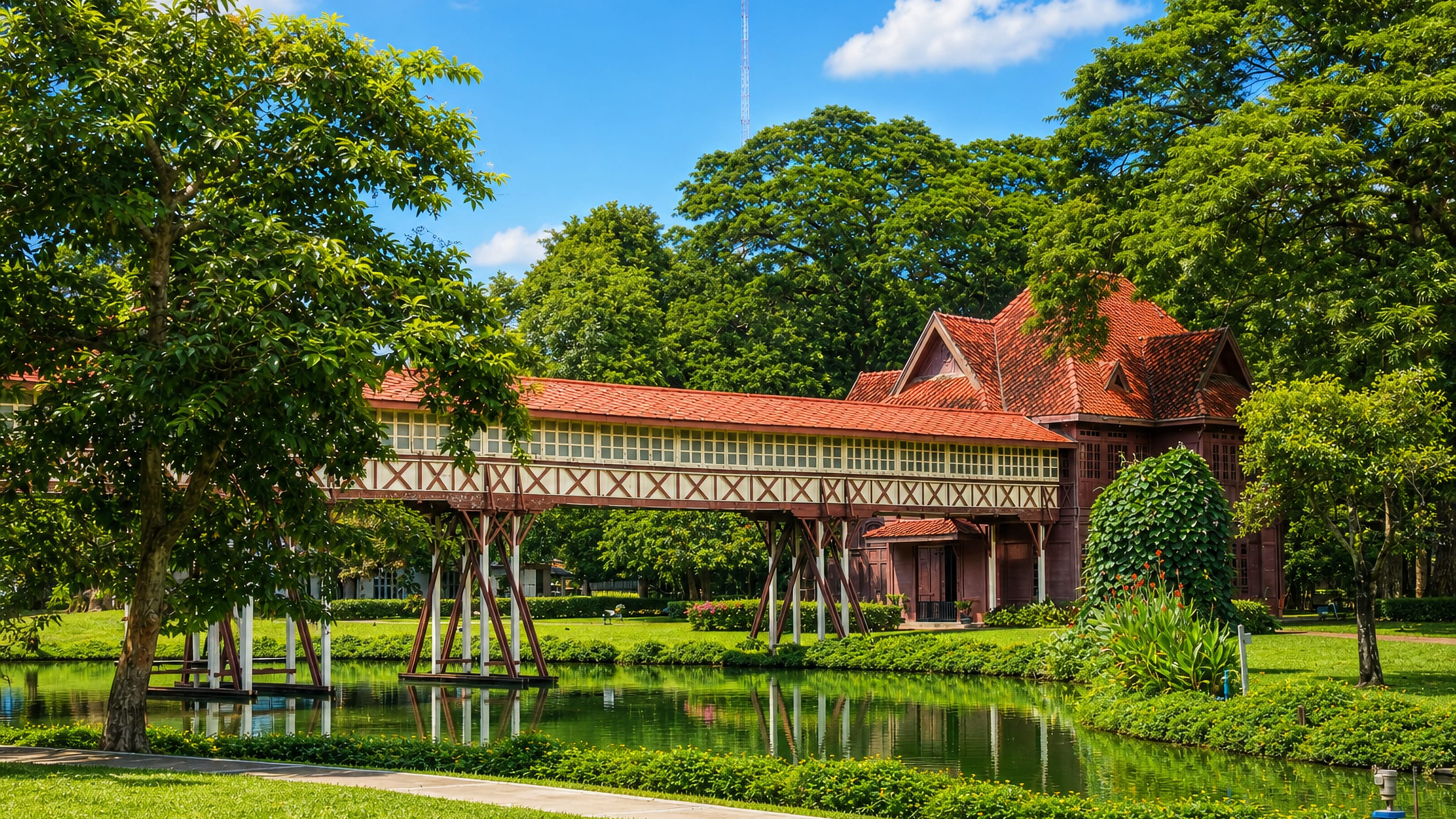 Covered teak walkway and pavilion over a pond at Sanam Chandra Palace, Nakhon Pathom, Thailand.