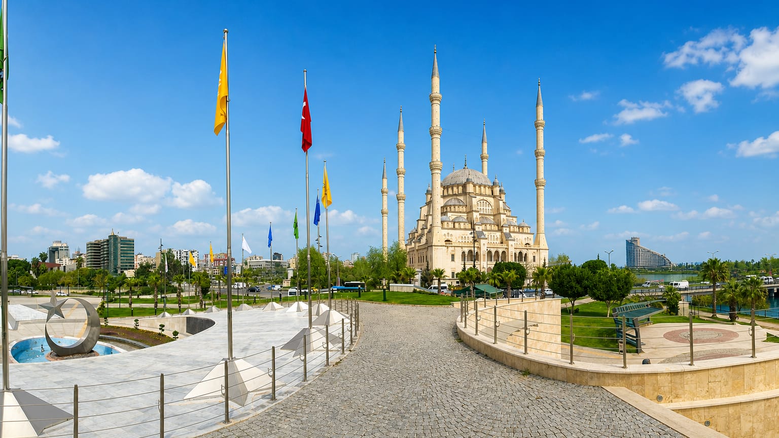 Sabanci Central Mosque with six minarets rising above Central Park and the Turkish flag in Adana