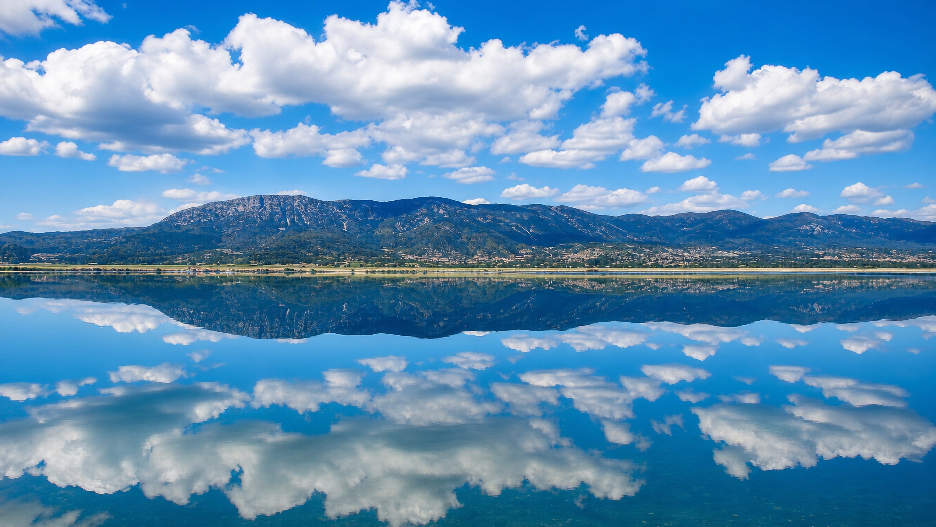 Mountains reflected in the still water of the lake beside Burdur, Turkey.