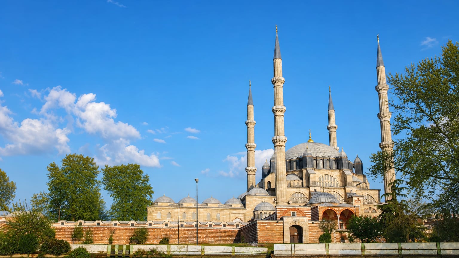 Selimiye Mosque's four minarets and central dome reflected in the river at Edirne, Turkey