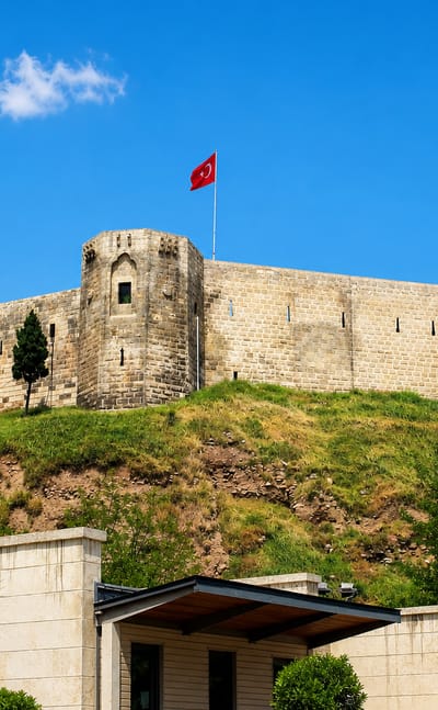 Gaziantep Castle flying the Turkish flag atop its grassy hill, Gaziantep, Turkey