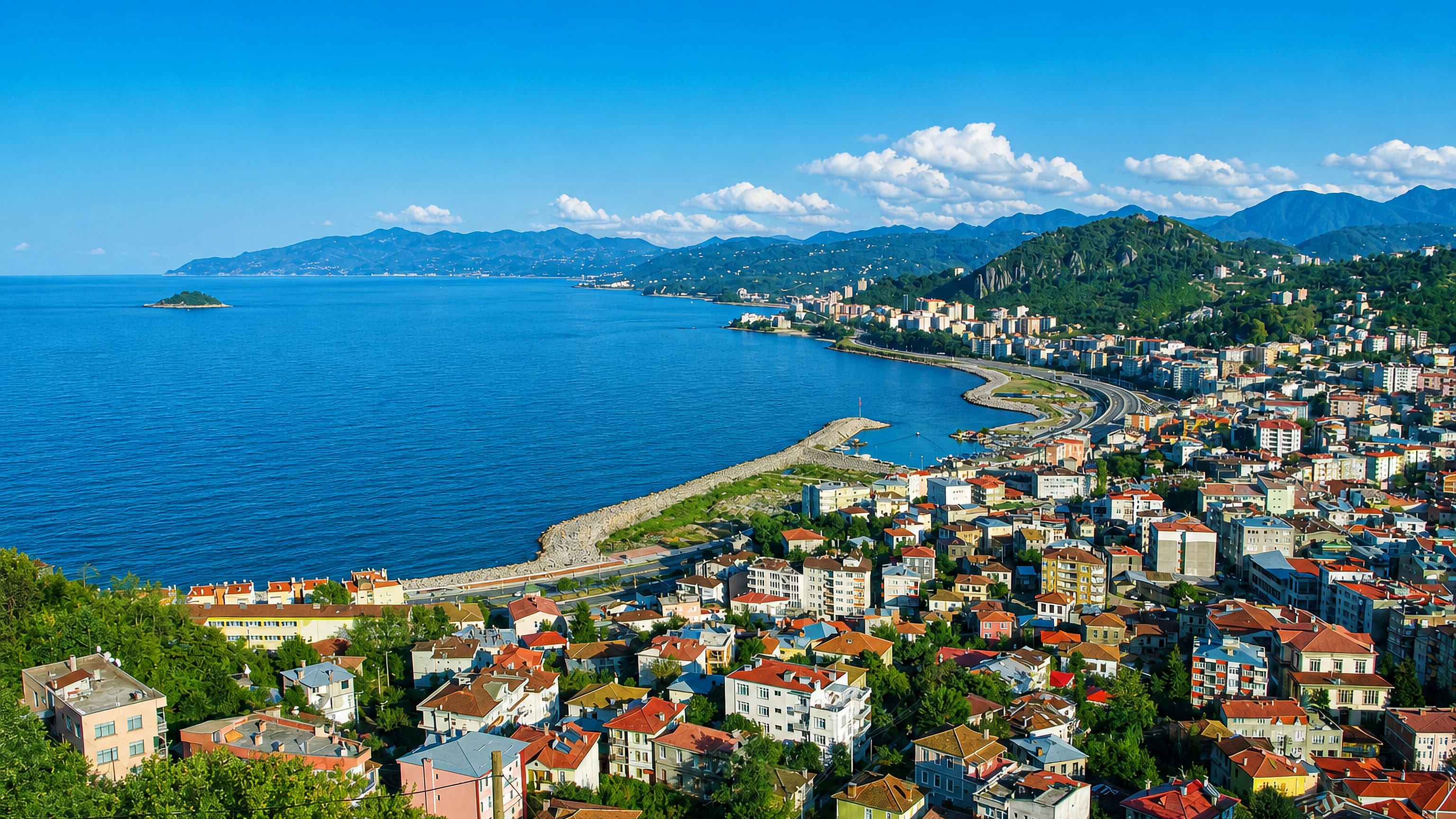 Giresun's Black Sea waterfront and hillside houses seen from above, with Giresun Island offshore.