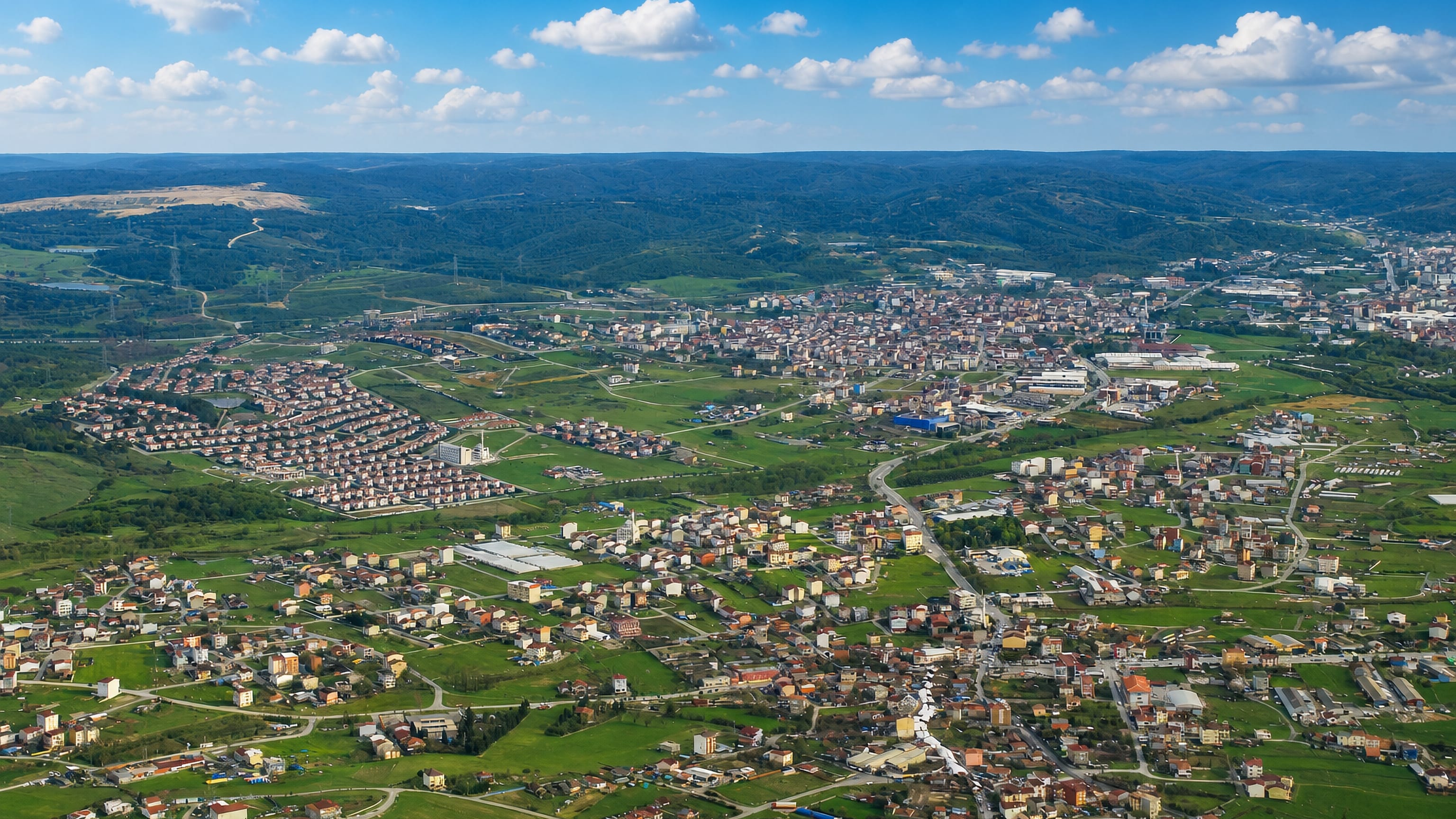 Aerial view over the low-rise sprawl and green fields of Arnavutkoy on Istanbul's northern fringe.