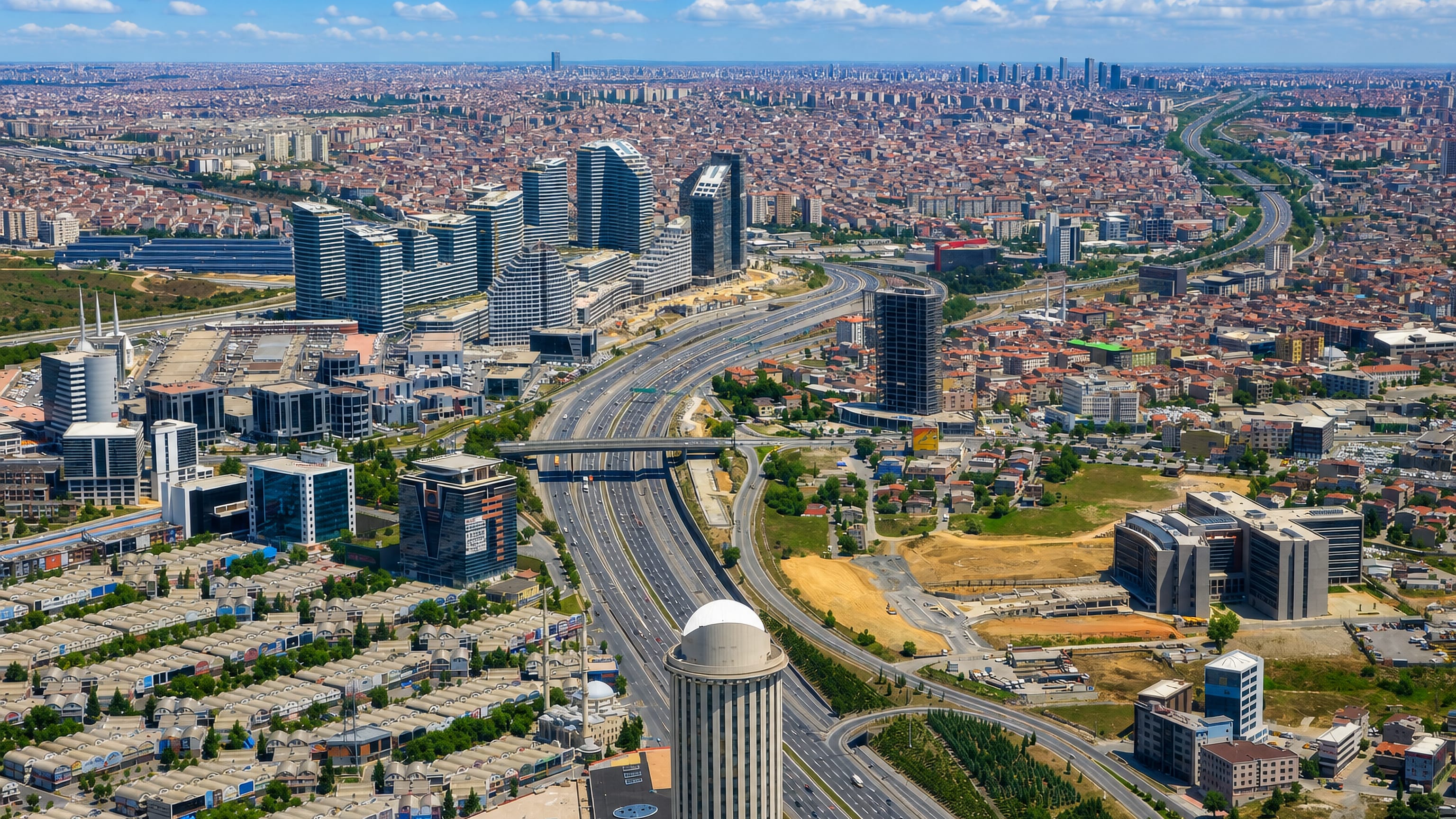 Aerial view of Esenler, Istanbul, with office towers and dense housing along the TEM motorway.