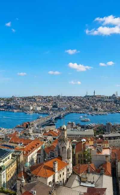 Istanbul's Golden Horn with the historic peninsula, imperial mosques, and Galata Bridge under blue sky
