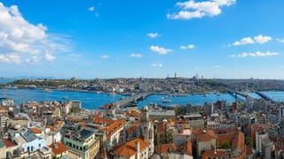Istanbul's Golden Horn with the historic peninsula, imperial mosques, and Galata Bridge under blue sky