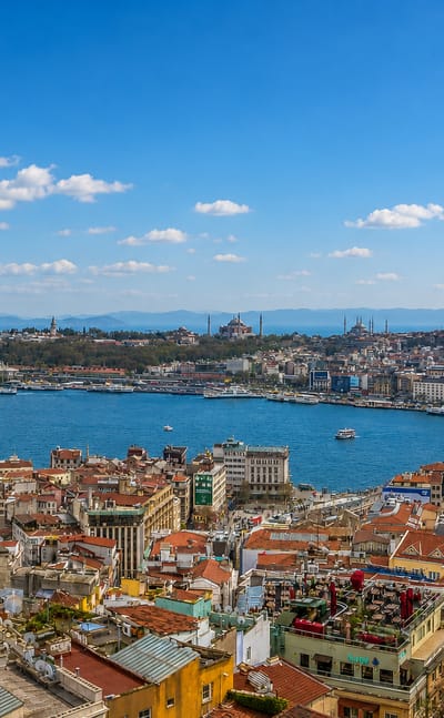Panorama of Istanbul's New City rooftops and the Galata Bridge over the Golden Horn toward the historic peninsula skyline