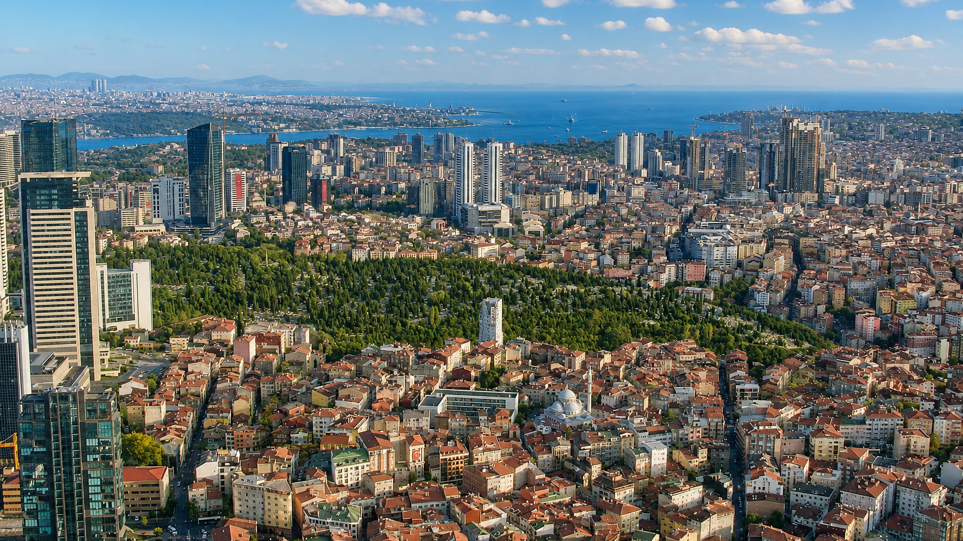 Aerial view over Sisli's dense rooftops and Mecidiyekoy high-rises toward the Bosphorus in Istanbul.